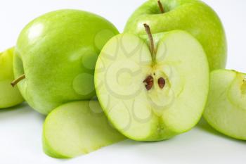 Whole and cut green apples