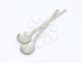 metal salad spoon and fork and green apple
