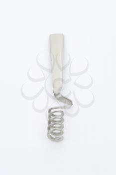 metal honey dipper on off-white background