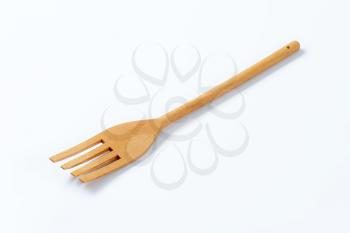 wooden fork on off-white background