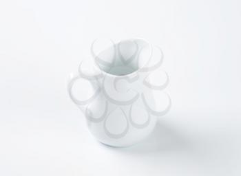 empty white porcelain milk jug