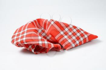crumpled checked red and white napkin
