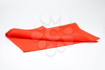 Red cotton place mat folded in half