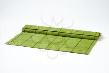 green bamboo place mat on white background