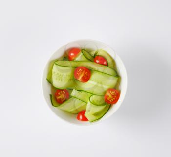 bowl of sliced cucumber and cherry tomatoes