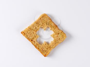 Slice of bread with cut out four leaved clover shape