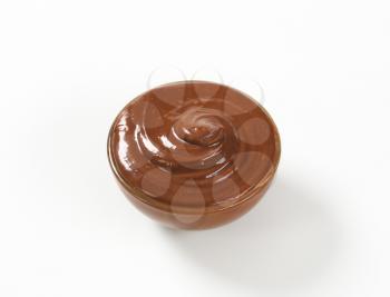bowl of chocolate spread on white background