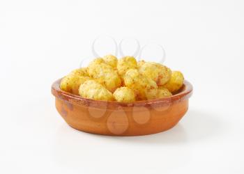 crunchy peanut puffs in terracotta bowl