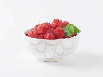 bowl of fresh raspberries on white background