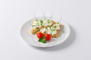 bread with cottage cheese and chives on white plate