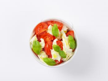 bowl of fresh caprese salad on white background