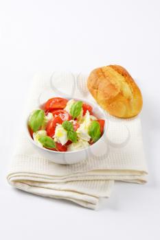 bowl of caprese salad and fresh bun