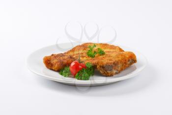 fried breaded pork chop on white plate