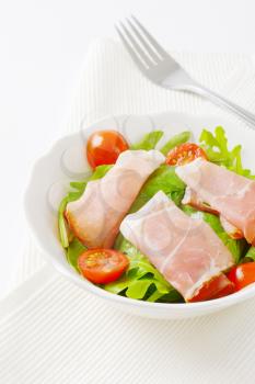 bowl of salad greens with Black Forest ham and cherry tomatoes