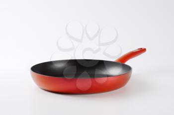 red frying pan with nonstick surface