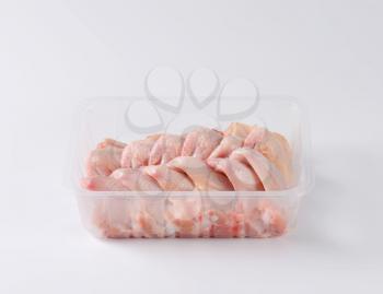 raw chicken wings in plastic container