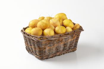raw potatoes in wicker basket