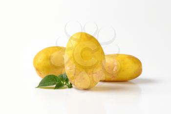 three new potatoes on white background
