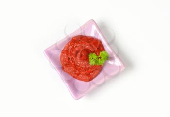 thick tomato sauce on square pink plate