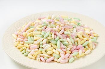 heap of colored puffed rice on plate