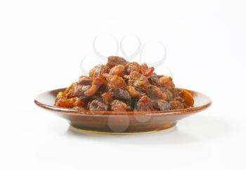 heap of raisins on plate