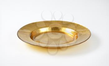 Empty gold plate with wide rim
