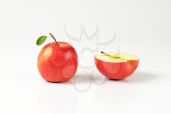 one and a half red apples on white background