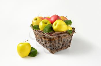 red and yellow apples in wicker basket