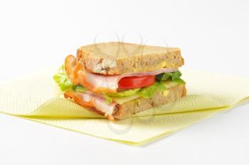 sandwich made from continental bread, ham, cheese, lettuce and tomato