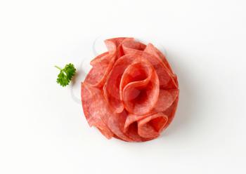 thin slices of salami on white background