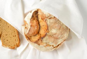 fresh artisan bread in white napkin