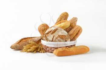 Various types of bread in a basket and next to it