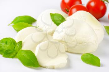 detail of mozzarella, cherry tomatoes and fresh basil - ingredients for caprese salad