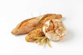freshly baked bread and baguettes on white background