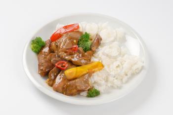 dish of meat and vegetable stir fry with rice