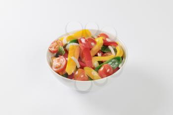 Bowl of fresh bell pepper strips and halved cherry tomatoes