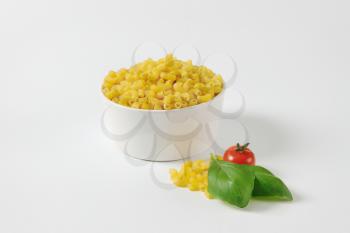 Heap of uncooked macaroni in a bowl