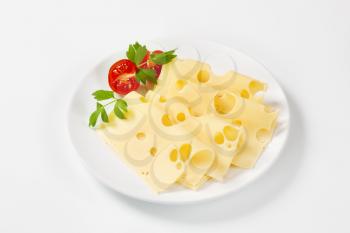thin slices of emmental cheese on white plate
