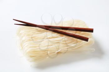 Bundle of dried rice noodles and wooden chopsticks
