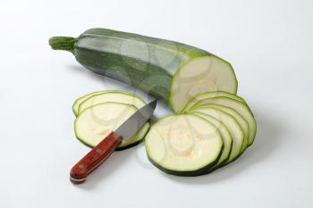 sliced fresh zucchini on a white background