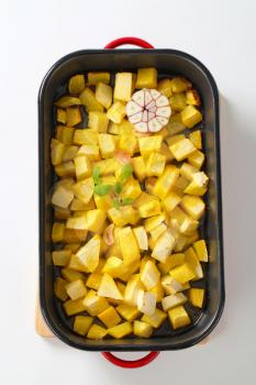 Diced pumpkin roasted with garlic in a baking pan