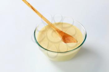 bowl of raw batter and wooden spoon