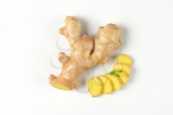 sliced fresh ginger on white background