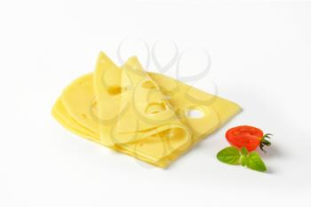 thin slices of Swiss cheese on white background