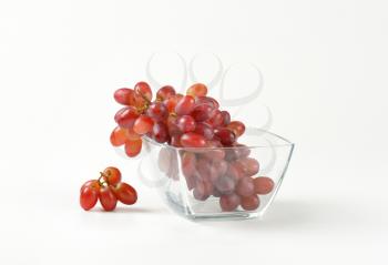 bunch of red grapes in glass bowl
