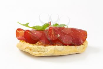 Italian dry biscuit with thin slices of smoked beef