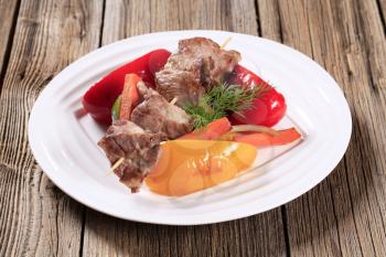 Roasted venison on a skewer and vegetables