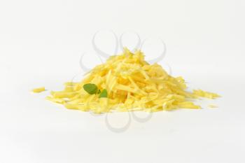 heap of grated cheese on white background