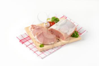 raw boneless pork loin chops on cutting board