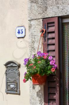 Potted plants decorating the front door of a house in the village of Bagni San Filippo, Tuscany, Italy